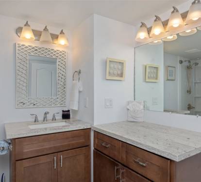 Unwind in your elegantly designed bathroom featuring rich wood vanities, marble countertops, and warm lighting that creates the perfect retreat.