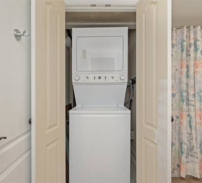 Your in-unit washer and dryer make extended stays effortless, tucked conveniently in this well-designed space.
