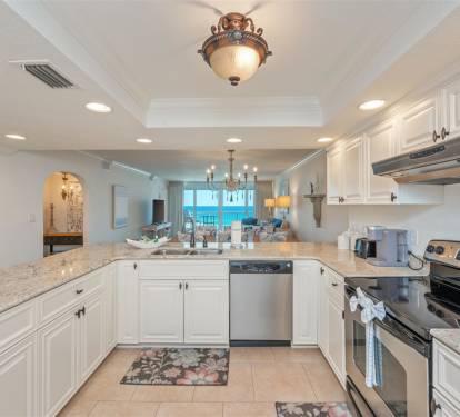 Your elegant kitchen flows seamlessly into a bright living space with stunning ocean views, featuring granite countertops and premium stainless appliances.