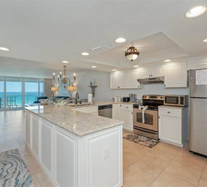 Your fully equipped kitchen features granite counters, stainless appliances, and opens to breathtaking ocean views.
