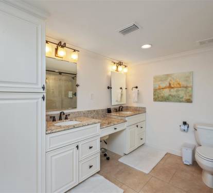 Step into your spacious master bathroom featuring elegant dual vanities, granite countertops, and beautiful natural light for your morning routine.