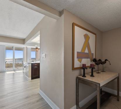 You'll love this stylish open-concept layout with modern artwork and glimpses of your private balcony beyond.