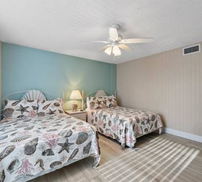 Sleep peacefully in your coastal-themed twin bedroom with seashell bedding and calming aqua walls that invite ocean dreams.