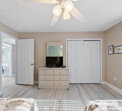 Your spacious bedroom features comfortable furnishings, ceiling fan, flat-screen TV, and ample closet space for all your belongings.
