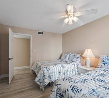 Drift off peacefully in your comfortable twin bedroom, where tropical bedding and gentle ceiling fan breezes create the perfect retreat.