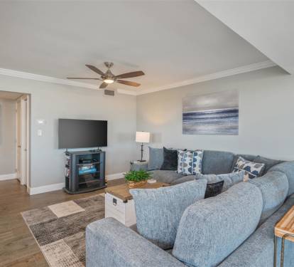 Unwind in your spacious living room where plush sectional seating and warm lighting create the perfect atmosphere for relaxing evenings.