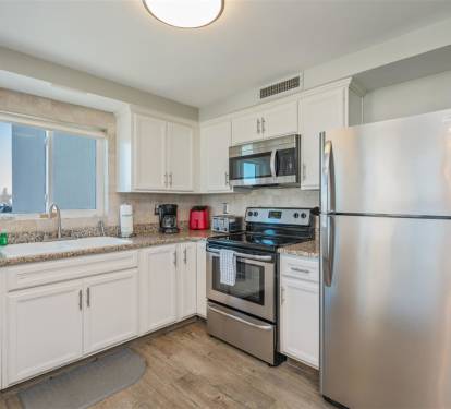 Your fully equipped kitchen features stainless steel appliances, granite counters, and bright natural light for preparing memorable meals during your stay.