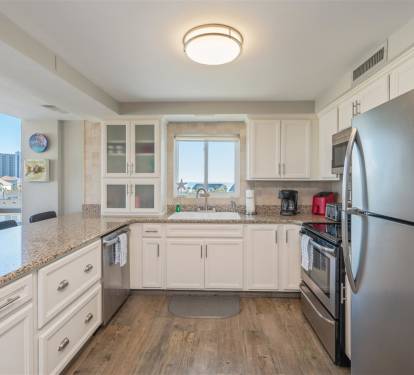 Your fully-equipped kitchen awaits with granite counters, stainless appliances, and stunning city views to inspire your culinary adventures.