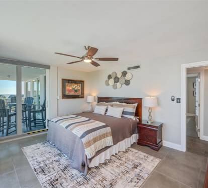 Step into your peaceful bedroom retreat where ocean breezes flow through sliding doors to your private balcony.