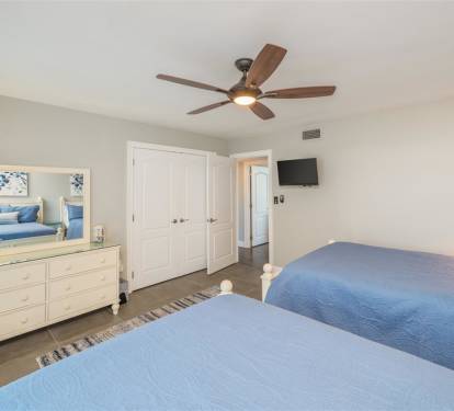 Drift off in this serene twin bedroom where coastal blues meet crisp whites, creating your perfect peaceful retreat.