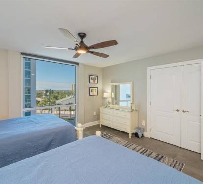 Rest peacefully in your twin bed sanctuary with city views and gentle ceiling fan breezes for optimal comfort.