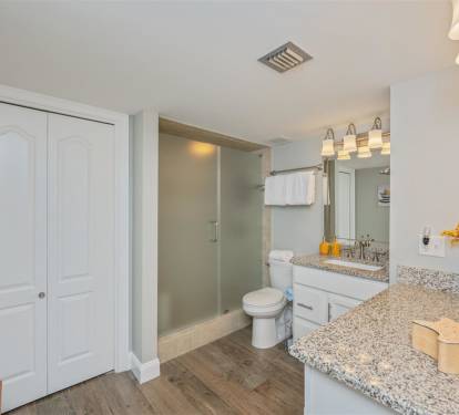 Refresh in your spacious bathroom with granite counters, modern shower, and thoughtful touches like fresh flowers welcoming you home.