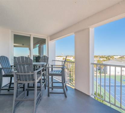 Relax in your private balcony chairs while enjoying panoramic views of tennis courts and the neighborhood beyond on sunny days.