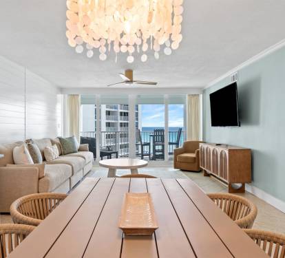 Relax in your stylish living space featuring coastal-inspired decor, comfortable seating, and a spectacular balcony view.