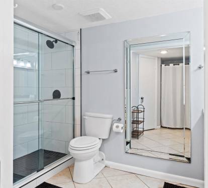 Step into your private sanctuary with a spacious glass-enclosed shower, modern fixtures, and elegant tile work that creates the perfect morning retreat.