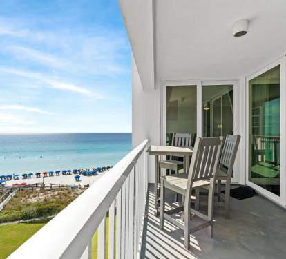 Your private balcony with dining table overlooks pristine white sand beaches and turquoise waters—perfect for morning coffee or sunset dinner.