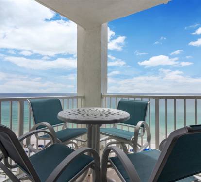 Sip your morning coffee while watching waves crash below from this oceanfront balcony with comfortable seating.