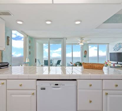 Prepare your favorite meals in this bright, beachfront kitchen while soaking in stunning ocean views through floor-to-ceiling windows.