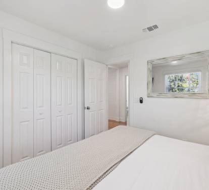 King Guest Suite - Offering Ample Storage + Flat-Screen TV