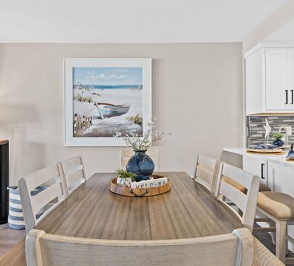 Gather around this coastal-inspired dining table for memorable meals with loved ones in your serene beachside retreat.