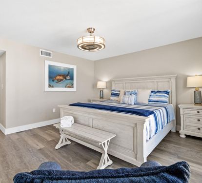 Your coastal bedroom features calming blue accents and white furnishings, creating a serene retreat for restful nights.