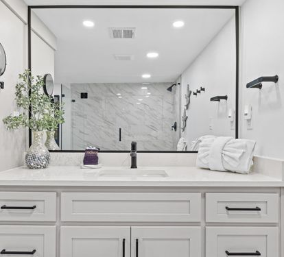 Step into your spa-like bathroom featuring elegant marble shower, pristine vanity, and luxurious amenities for ultimate relaxation.