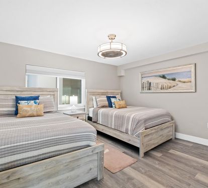 Drift off in this peaceful Queen bedroom with coastal-inspired decor and premium linens for your perfect night's rest.