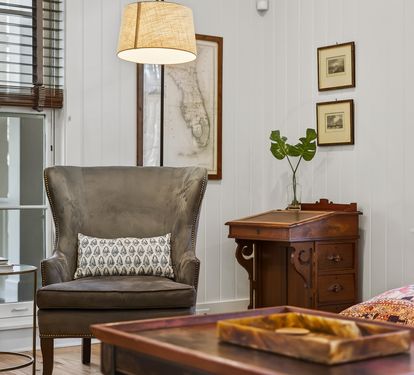Sink into this elegant wingback chair in your bright living space, surrounded by thoughtful details and warm natural light.