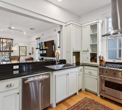 Your gourmet kitchen awaits with gleaming granite counters, professional-grade appliances, and elegant white cabinetry for inspired home cooking.