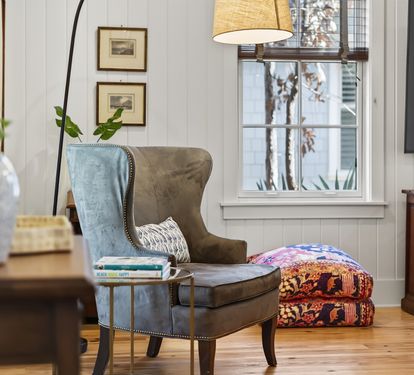 Curl up in your cozy reading nook with a plush wingback chair, warm lighting, and peaceful garden views.
