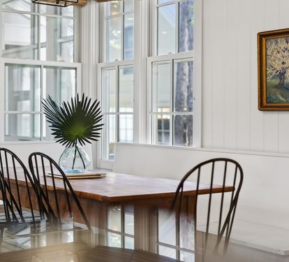 Gather around this beautiful dining table where natural light streams through windows, creating the perfect spot for your morning coffee or evening meals together.