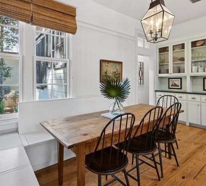 Gather around this rustic wooden dining table where your group can share memorable meals in this bright, welcoming space with built-in storage.