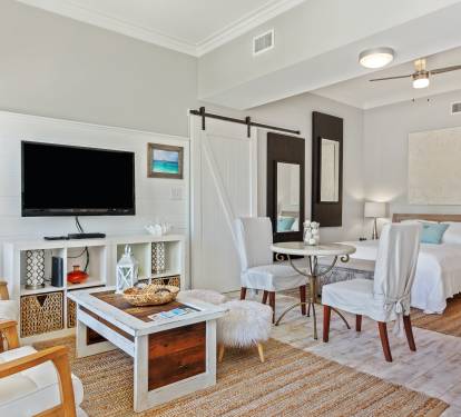Cozy 30A studio with a queen bed, sleeper sofa, and coastal décor—just a short walk to the beach. Bright, open layout with TV, dining area, and beachy charm throughout.