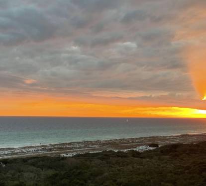 The sun is setting over the Gulf of Mexico.