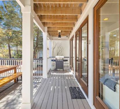 Fire up the grill and eat dinner on the back deck. Big table, open sky, good food — this is what a 30A summer night looks like.