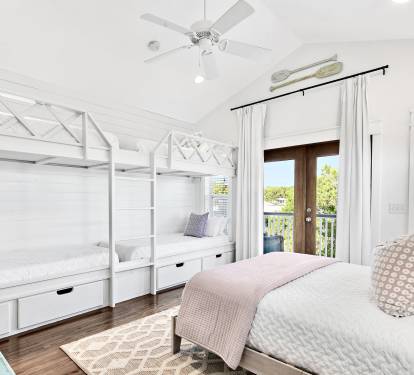 The 3rd floor bunk room: four twin XL bunks, a queen bed, and a dedicated wet bar with mini fridge. Comfortable for adults...or the kids get their own floor — everyone wins!