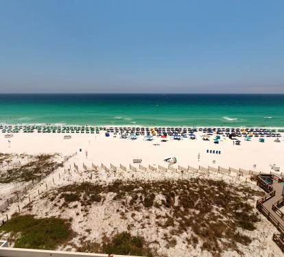 Stunning beachfront location with white sand shores and emerald waters stretching to the horizon, offering easy access to sun-soaked relaxation.