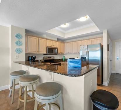 Your open kitchen features granite countertops, stainless steel appliances, and a breakfast bar perfect for morning coffee or casual dining together.