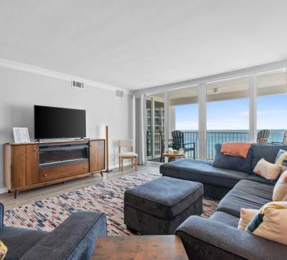 Unwind in your elegant living room with stunning ocean views through floor-to-ceiling windows. Sink into the plush sectional and enjoy your perfect coastal retreat.