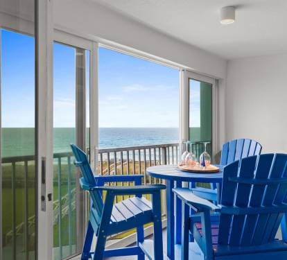 Your private balcony awaits with ocean views and comfortable seating for morning coffee or sunset cocktails.