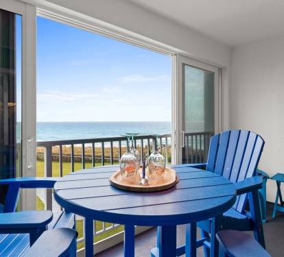 Sip wine at your private table while endless ocean views stretch to the horizon from your seaside balcony retreat.