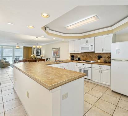 Cook with confidence in your spacious kitchen featuring granite counters and modern appliances, with stunning ocean views as your backdrop.