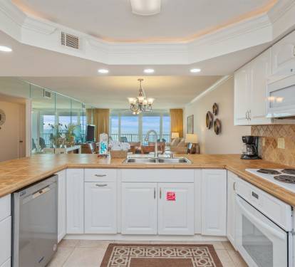 Your spacious kitchen opens to stunning ocean views, featuring modern appliances and elegant finishes for memorable vacation meals.
