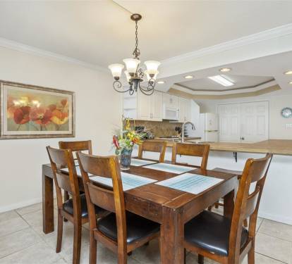 Gather around your elegant dining table for memorable meals, with a spacious kitchen just steps away for easy entertaining.