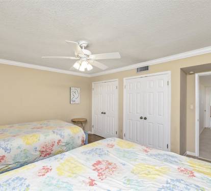 Rest peacefully in your bright bedroom with twin beds, ceiling fan, and ample closet storage for all your vacation essentials.