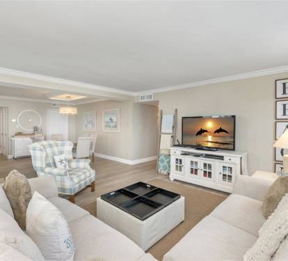 Sink into plush sofas and unwind in your elegantly appointed living space, where coastal charm meets modern comfort for perfect relaxation.
