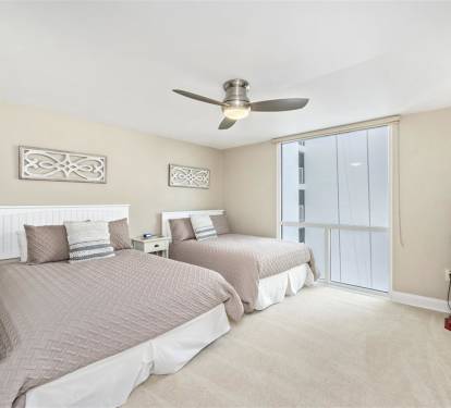 Drift off to sleep in your comfortable twin bedroom, featuring coastal charm and a gentle ceiling fan to keep you cool all night.