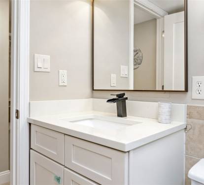 Your bright bathroom features modern fixtures and pristine white vanity with ample counter space for all your essentials.