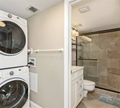 Your own in-suite washer and dryer make extended stays effortless, while the elegant bathroom features modern finishes and a spacious glass shower.