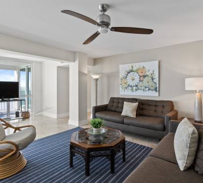Relax in your stylish living room with ocean views, comfortable seating, and gentle ceiling fan breezes.
